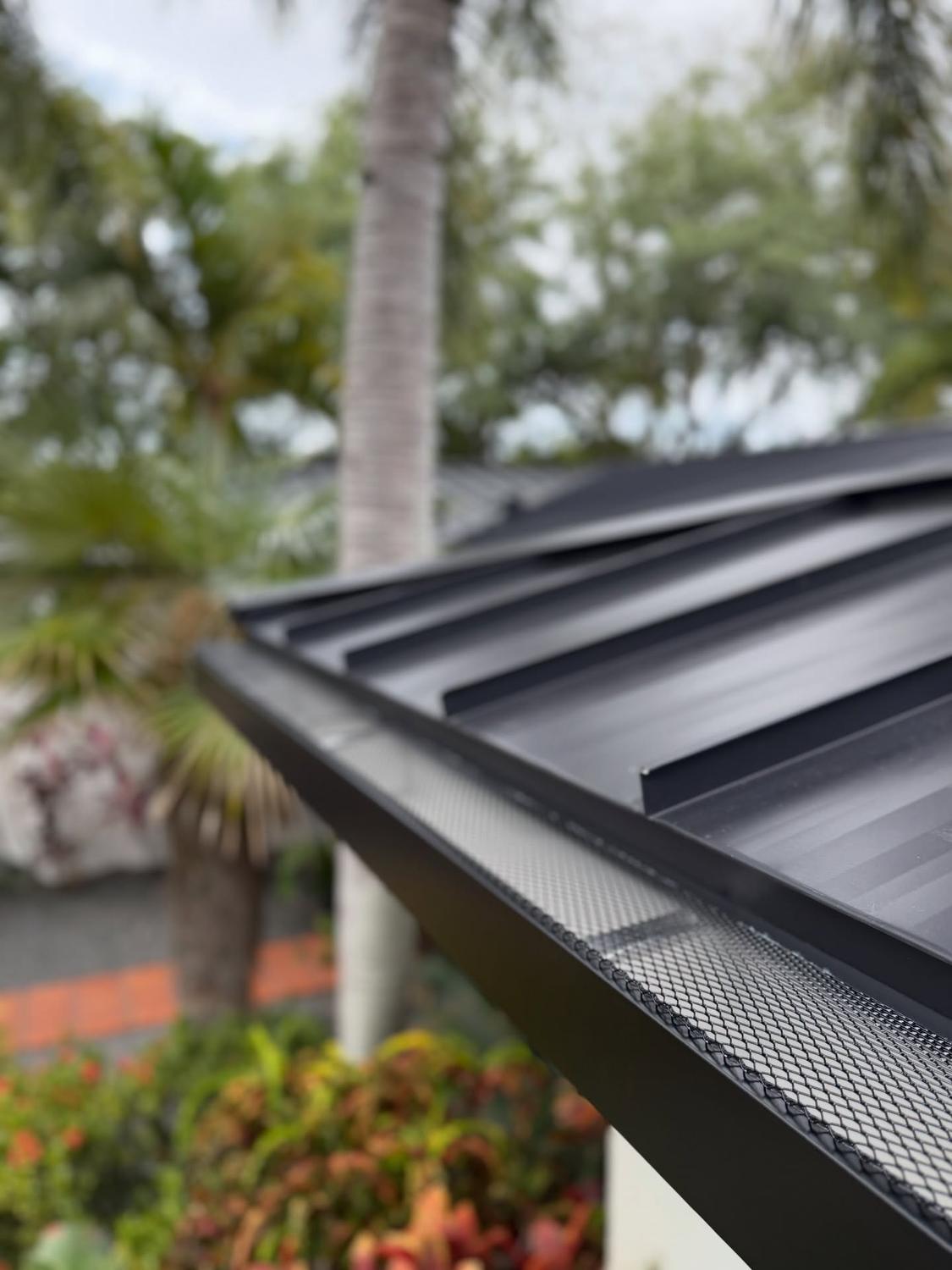 Gutter and roof edge being checked on a metal roof